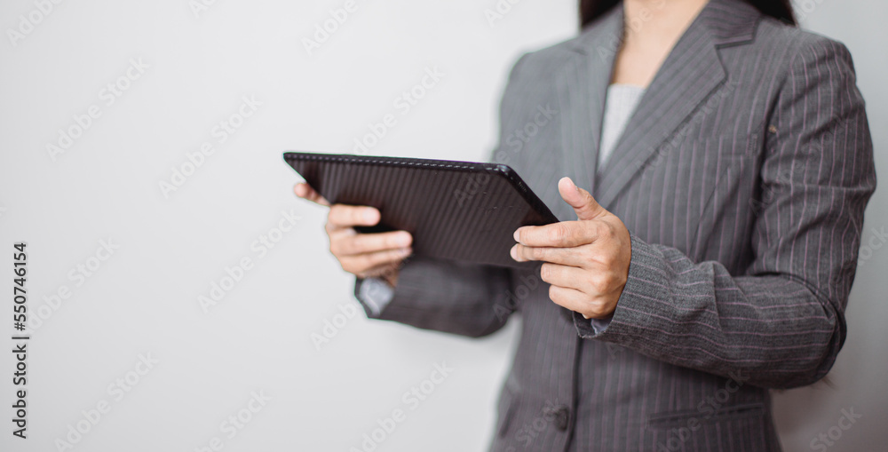 Asian businesswoman working at home using tablet device, browsing internet playing social media in video call meeting with colleagues and coworkers planning innovative ideas, quarantine self-isolation Asian businesswoman working at home using tablet device, browsing internet playing social media in video call meeting with colleagues and coworkers planning innovative ideas, quarantine self-isolation