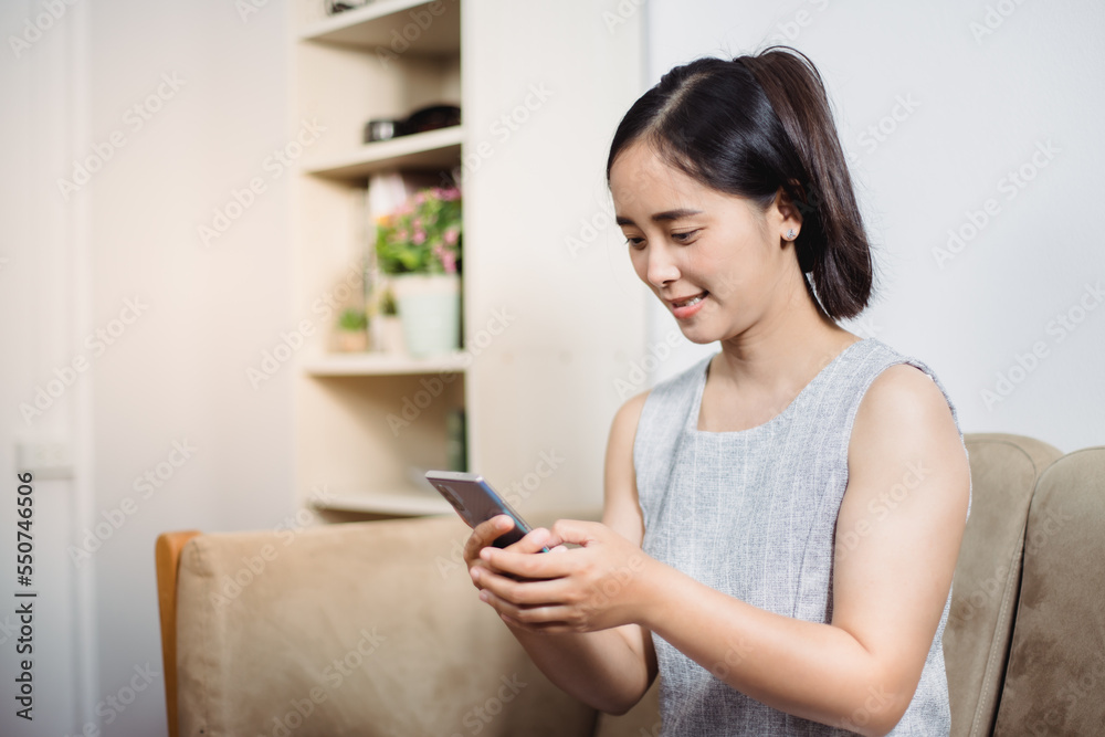 Cheerful mature woman using smartphone working at home office Cheerful mature woman using smartphone working at home office