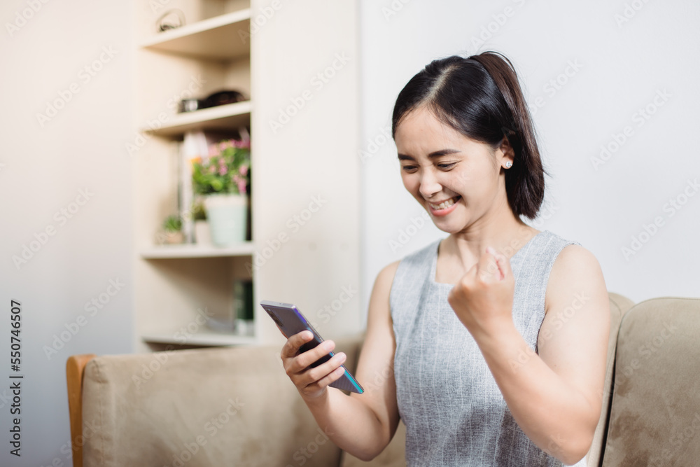Cheerful mature woman using smartphone working at home office Cheerful mature woman using smartphone working at home office