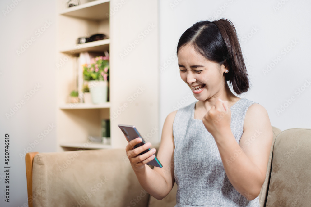 Cheerful mature woman using smartphone working at home office Cheerful mature woman using smartphone working at home office