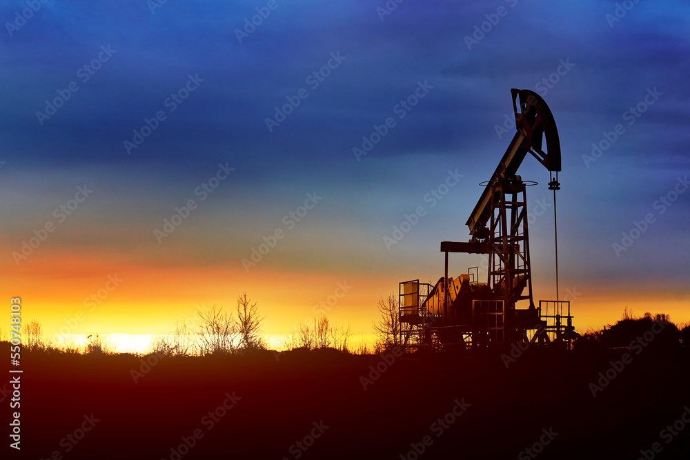 Prairie Oil Pump Jacks. One pump jack producing oil. Crude oil is a major economic driver. Abstract image