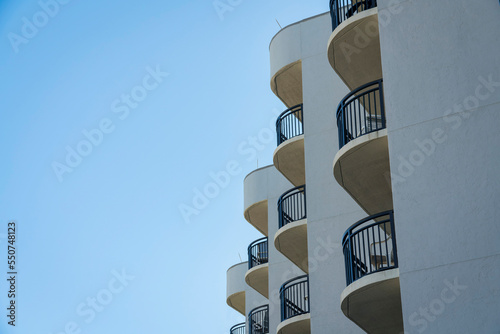 Corner of a building with curved balconies in a low angle view at Destin  Florida