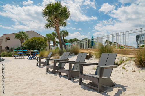 Lounge chairs near the grasses beside the fence railings in Destin, Florida