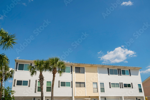 Townhomes with light yellow and white wood lap sidings at Destin, Florida