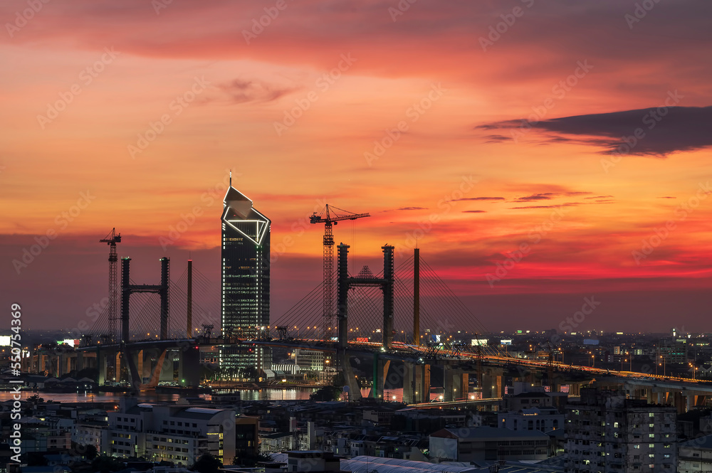 Twilight brings to life the metropolis of Bangkok's new bridge building. 
