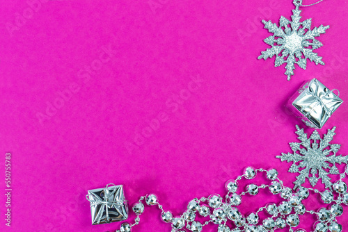 Christmas decorations on pink background. Christmas background. Merry Christmas greeting card, frame, banner. Space for text. Selective focus.