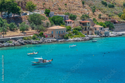 view of  Limeni village with fishing boats in  turquoise waters and the stone buildings as a background  in Mani  South Peloponnese   Greece.