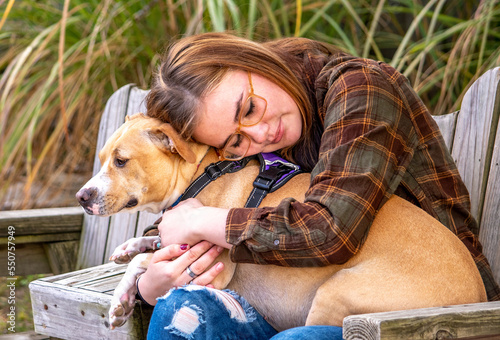 Girl  with epilepsy hugs her seizure support dog