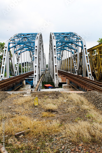 Karawang, Indonesia, 25 November 2022: The blue sky railway bridge is centered in Karawang