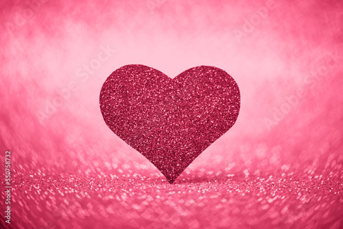 Glitter heart as copy space for Valentine's day card in Viva Magenta Red color.
