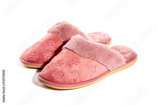 Pink warm women's slippers on a white background