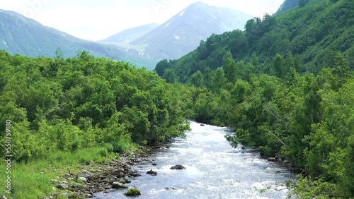 Kamchatka. Mountain fast rapids river with pebble banks-bottom, mixed sand-and-shingle spits and low-growing deciduous floodplain forests photo