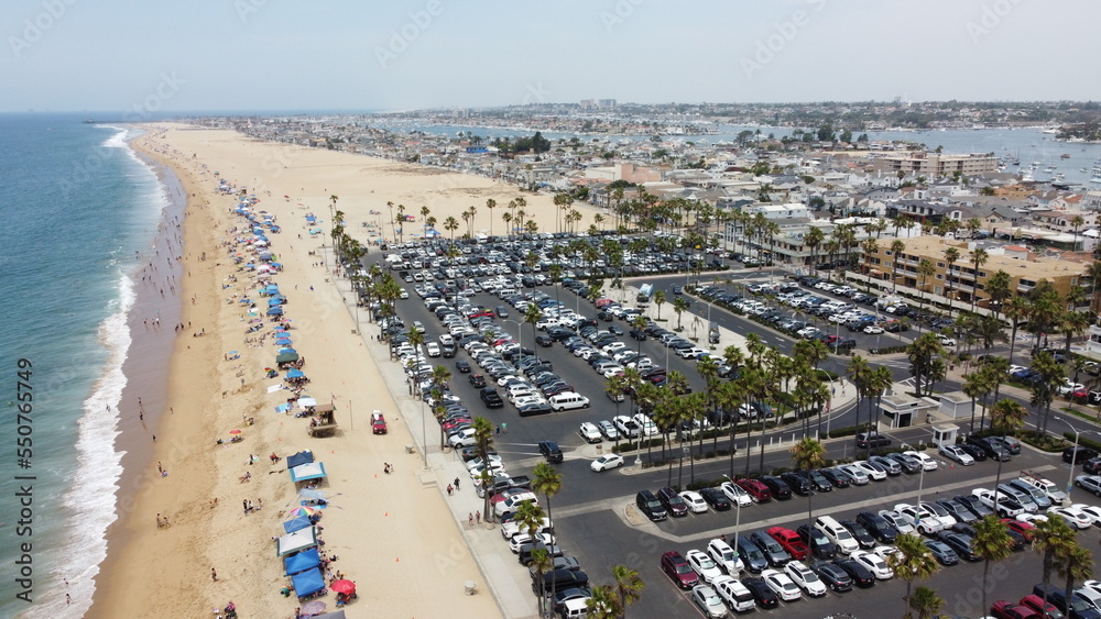 Aerial view of California Balboa island city during active blue beach sandy shore in summer. Top view of island peninsula 