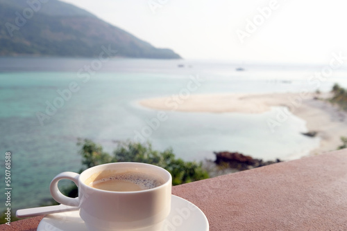 Coffee cup with beautiful beach in the summer time. Concept travel, holiday and vacation. Nature landscape at Lipe island in Thailand.
