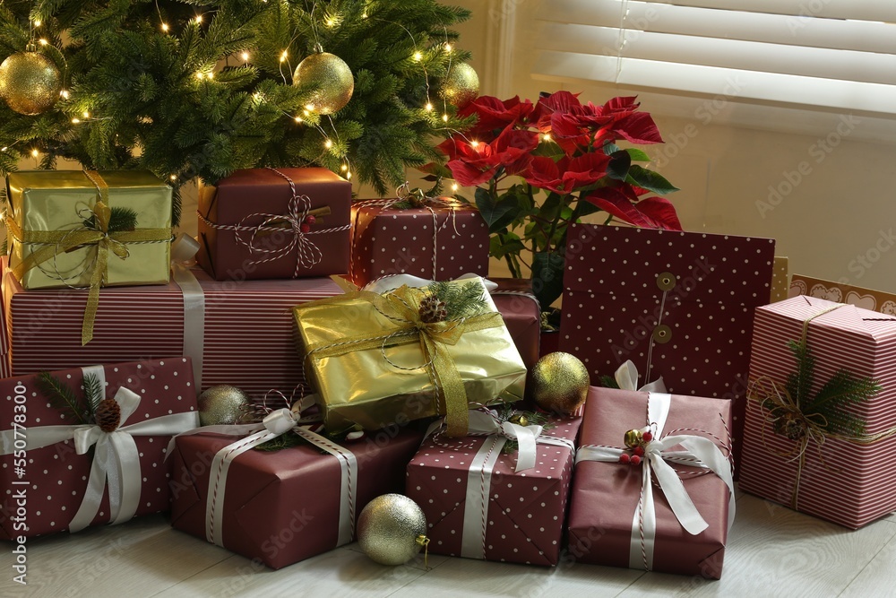 Many different gifts under Christmas tree indoors Many different gifts under Christmas tree indoors