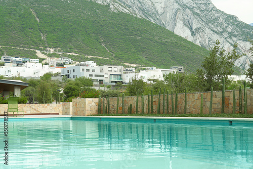 Outdoor swimming pool and beautiful mountain on background