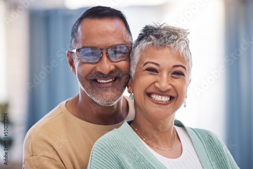 Portrait, love and senior couple hug with smile, loving and romantic together in lounge. Mexico, mature man and elderly woman embrace, happiness and bonding for relationship, marriage and cheerful.