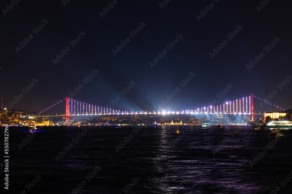 Istanbul night. Spotlight show on Bosphorus Bridge.