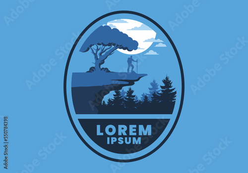 Mountain climbers standing on the edge of a cliff under a shady tree