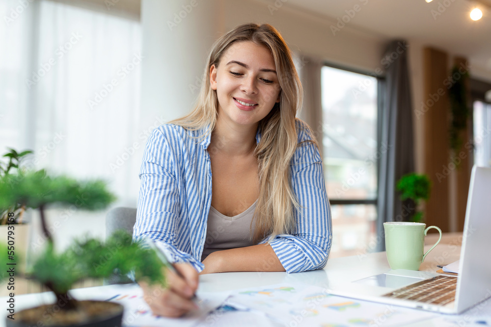 © Graphicroyalty - Woman working on computer at the desk from home, portrait of beautiful woman working in her office © Graphicroyalty - Woman working on computer at the desk from home, portrait of beautiful woman working in her office