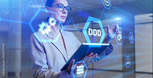 DDD Domain-driven design development concept. Young business woman pressing button on virtual screen.