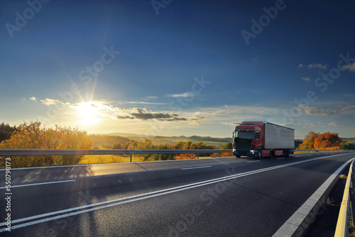 Landscape with a moving truck on the highway at sunset. © Jaroslav Pachý Sr.