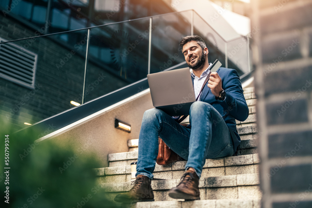 © ivanko80 - Portrait of smiling man,he is using laptop © ivanko80 - Portrait of smiling man,he is using laptop
