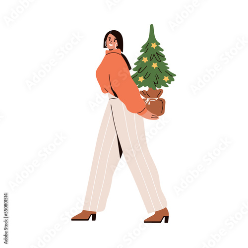 Happy woman holding Christmas tree. Young girl, office worker going, carrying...