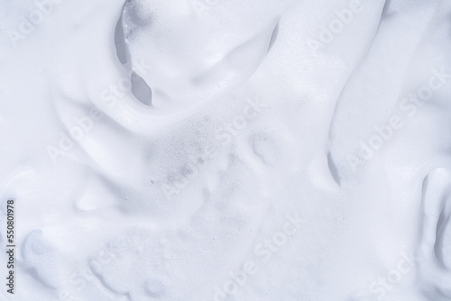 Shaving foam. Smooth White foam texture close up background. Creamy textured macro. Cosmetic product foamy smudges top view.
