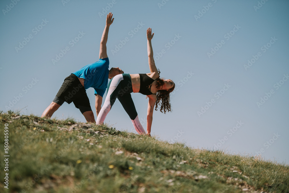 Close up of yoga couple with arms up