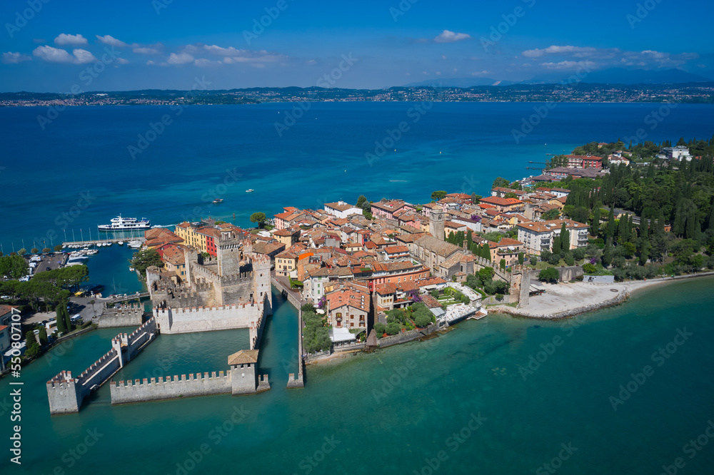 Aerial view on Sirmione sul Garda. Italy, Lombardy. Rocca Scaligera Castle in Sirmione. View by Drone. Sirmione, northern Italy. Medieval castle Scaliger on lake Garda.