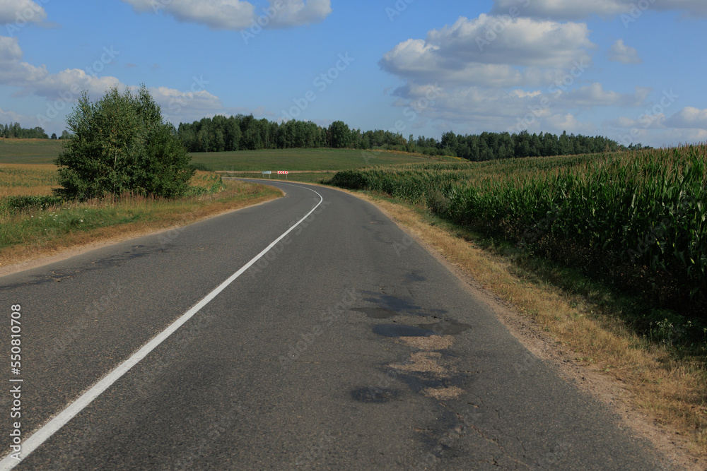 Highway wide road, transport and blue sky with clouds on a summer day