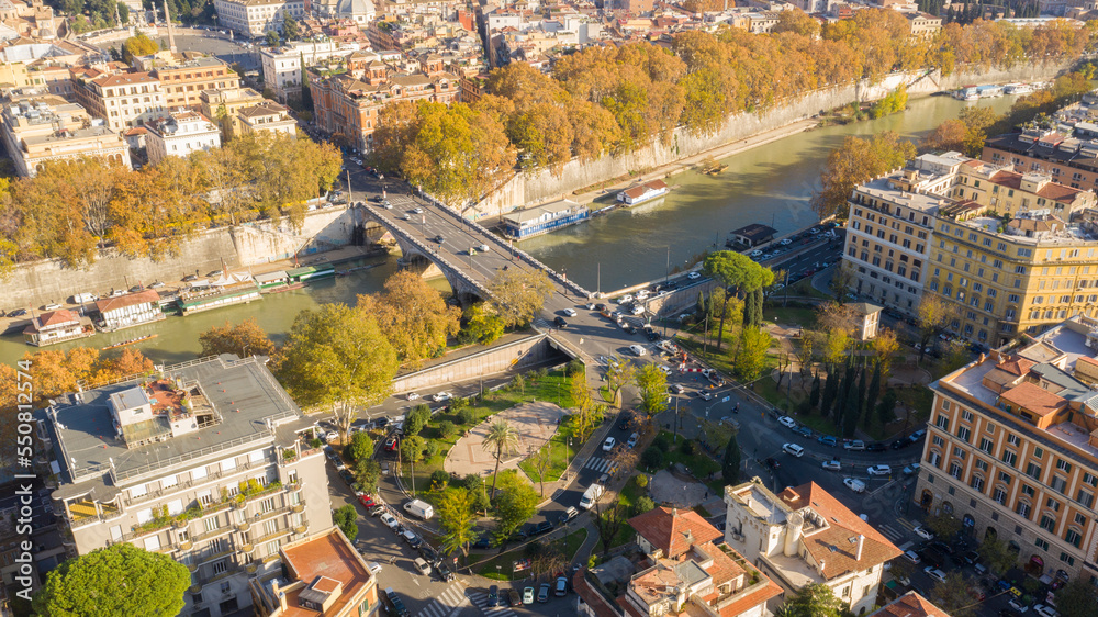 Aerial view over the Tiber River near Prati district in Rome, Italy. Autumn colors dye the trees along the river.