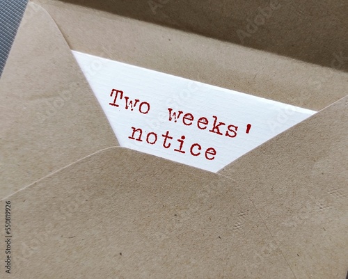 Craft envelope and document with typed text words - Two Weeks' Notice , means employee courtesy to give employer time to prepare for resignation and hiring someone else photo