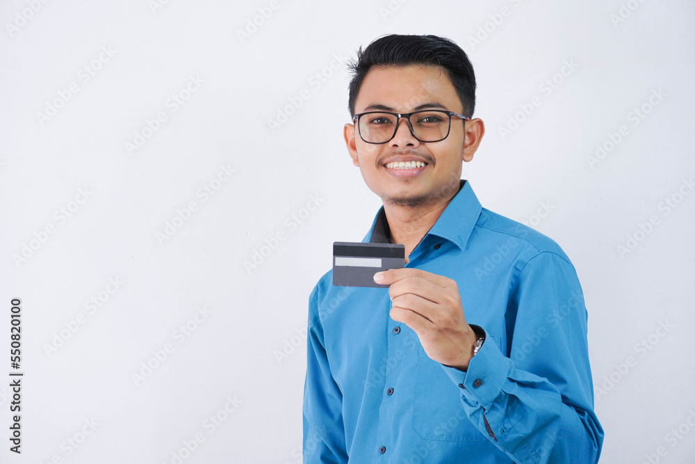 smile or happy young asian businessman with glasses holding credit card wearing blue shirt isolated on white background smile or happy young asian businessman with glasses holding credit card wearing blue shirt isolated on white background