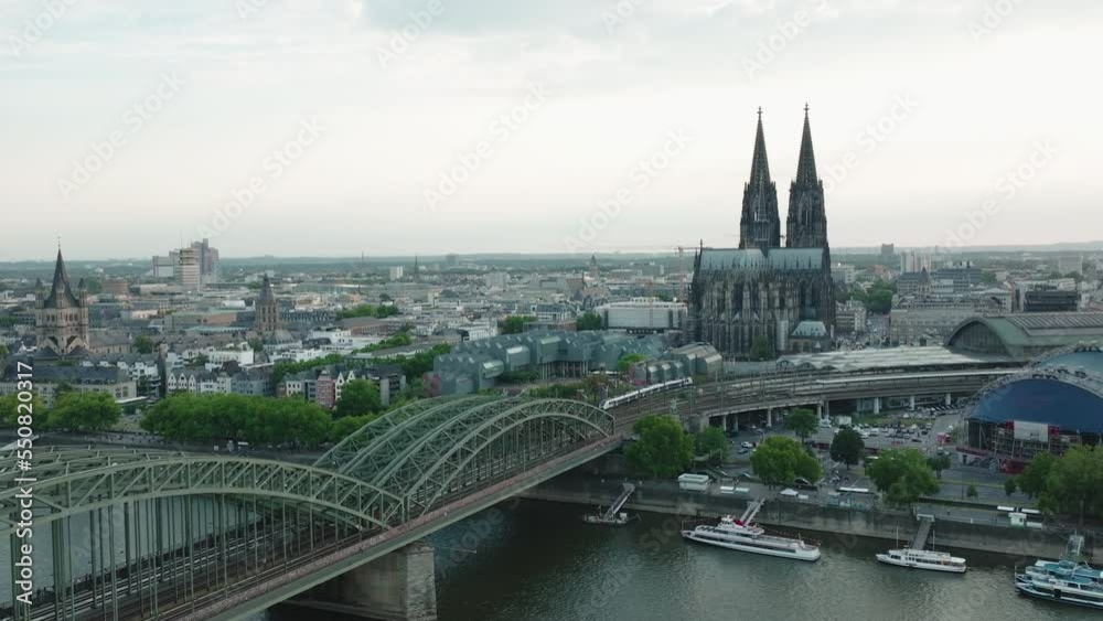 Drone moves to the right, the Cologne Cathedral in gloomy weather is in the center, the Hohenzoller Bridge with the Rhine is in the lower part of the picture Drone moves to the right, the Cologne Cathedral in gloomy weather is in the center, the Hohenzoller Bridge with the Rhine is in the lower part of the picture