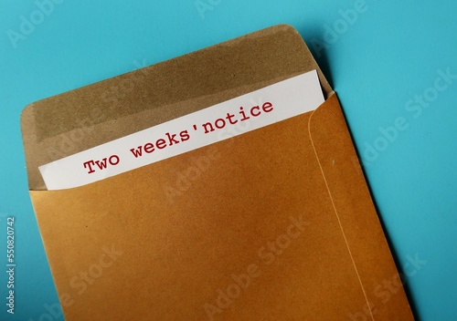 Office envelope and document with words - Two weeks' notice, means employee courtesy to give employer time to prepare for resignation and hiring someone else photo