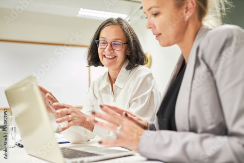 Two business women discussing website development