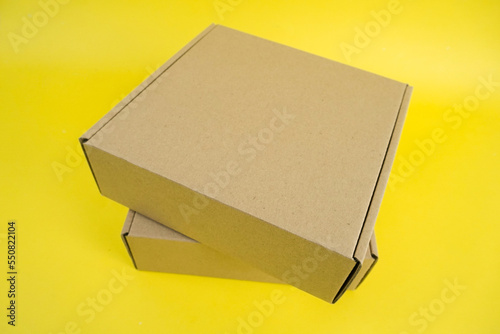 cardboard boxes of various shapes and positions isolated on a yellow background       