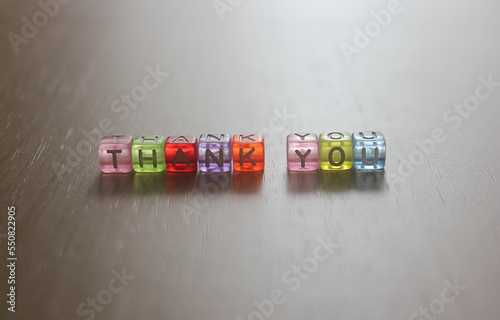 Thank you- word made from multicolored child toy cubes with letters. Thank you letter for business