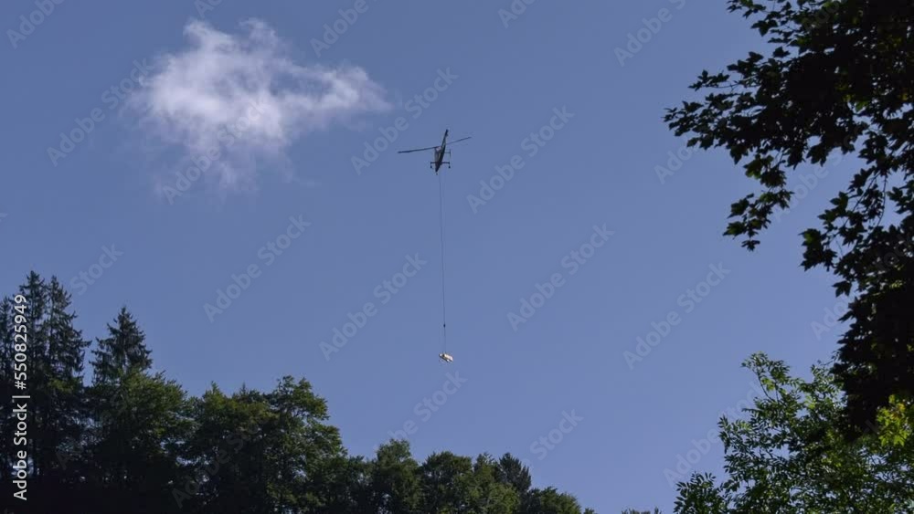 Helicopter Kamax transports wooden truss for wood bridge.