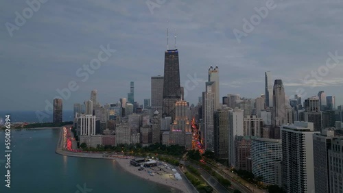 Aerial view around skyscrapers in Streeterville, cloudy Chicago, USA - orbit, drone shot photo