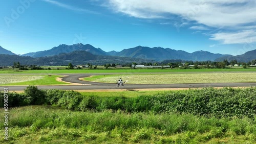 Helicopter Landed At Chilliwack Airport With Traffic Driving On Trans-Canada Highway In The Background In Canada. - aerial photo