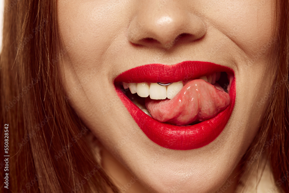 Seduction, flirting and temptation. Closeup view of female mouth with bright red lipstick. Beautiful wide smile of young woman with great healthy white teeth Seduction, flirting and temptation. Closeup view of female mouth with bright red lipstick. Beautiful wide smile of young woman with great healthy white teeth