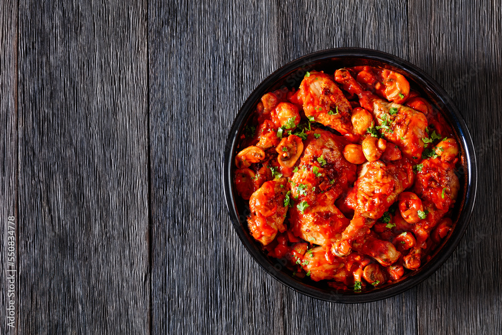 chicken stew with mushrooms in a tomato sauce chicken stew with mushrooms in a tomato sauce