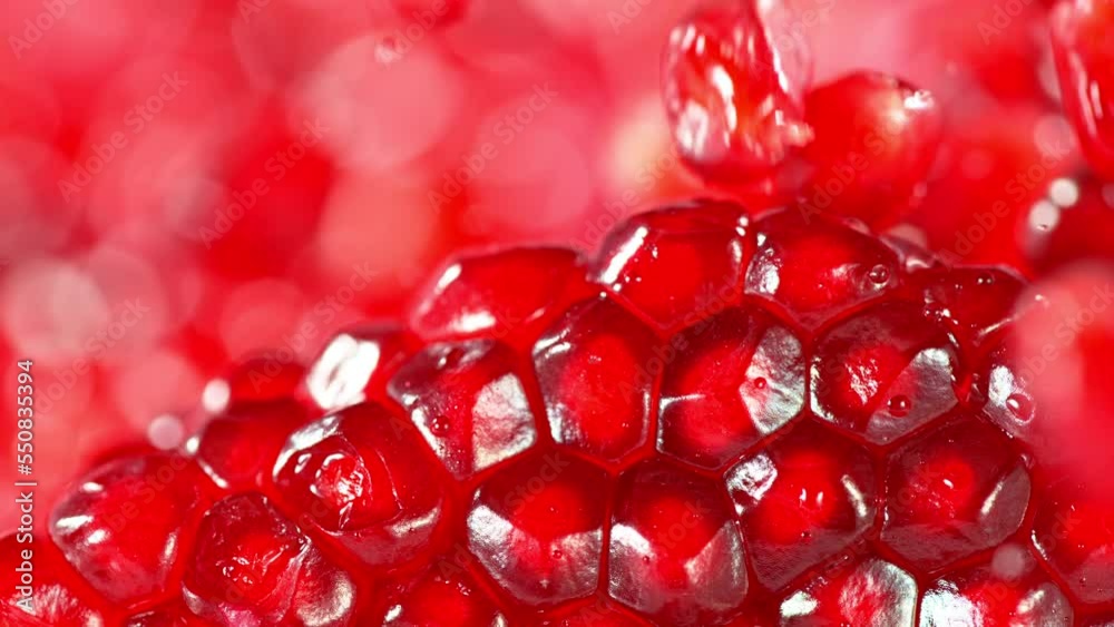 Fresh pomegranate pieces falling, macro shot, super slow motion filmed on high speed cinematic camera at 1000 fps Fresh pomegranate pieces falling, macro shot, super slow motion filmed on high speed cinematic camera at 1000 fps