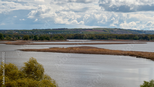 River landscape with islands and cloudy sky in the background
