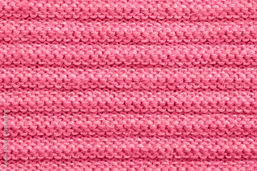 Knitted fabric of Viva magenta color. Soft focus Knitted fabric of Viva magenta color. Soft focus