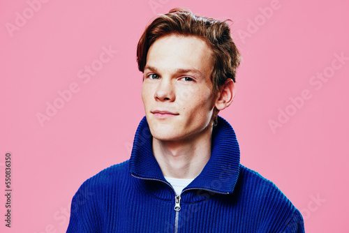 Bild auf Leinwand portrait of a handsome, sweet, nice guy in a blue zip-up jacket
