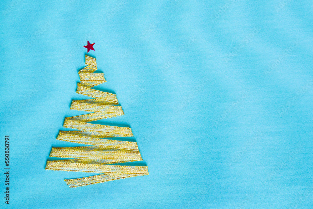 Christmas background, gold ribbon in the form of a Christmas tree on a